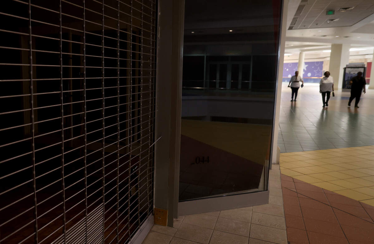 Community members walk the corridors closed storefronts at Ridgmar Mall in Fort Worth on Thursday, Aug. 27, 2026. will be demolished to make way for a logistics center.